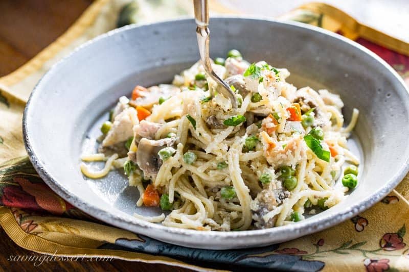 Turkey Tetrazzini Recipe - put your leftover turkey to work in this creamy, hearty casserole loaded with peas, carrots, Parmesan cheese and plenty of mushrooms. www.savingdessert.com #savingroomfordessert #turkey #tetrazzini #turkeycasserole #leftoverturkey #thanksgiving #turkeytetrazzini