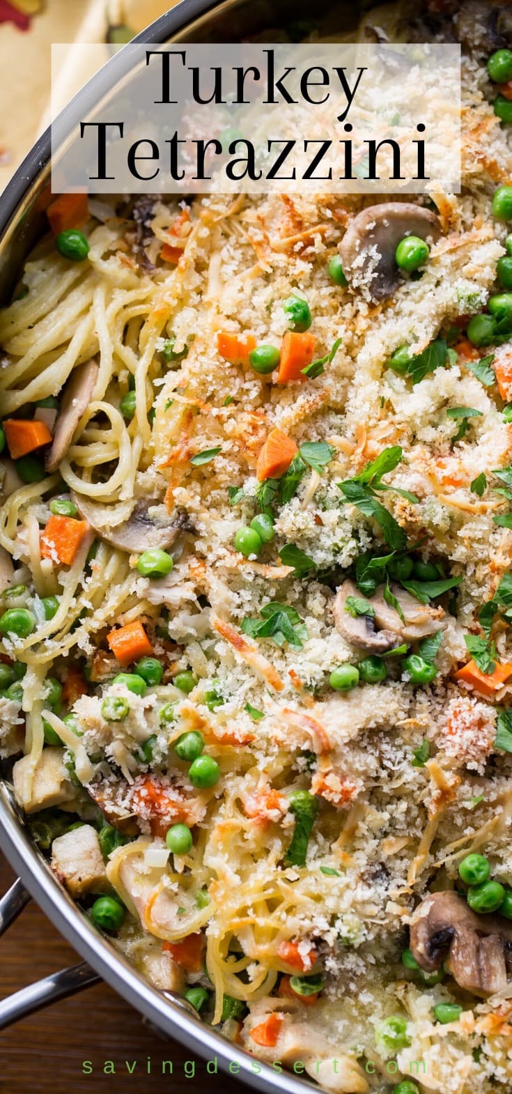 A skillet filled with Turkey Tetrazzini with peas, carrots, spaghetti noodles and mushrooms
