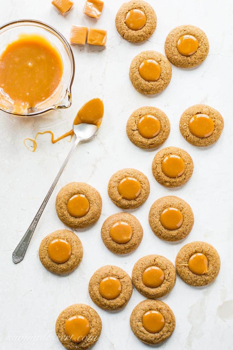 Ginger Molasses Thumbprint Cookies with Caramel ~ a terrific little molasses cookie with a crisp exterior, plenty of bite from the ginger, and a smooth, gooey milky caramel center.  www.savingdessert.com #savingroomfordessert #gingercookies #molassescookies #thumbprintcookies #thumbprint #christmascookies #cookies #caramelcookies
