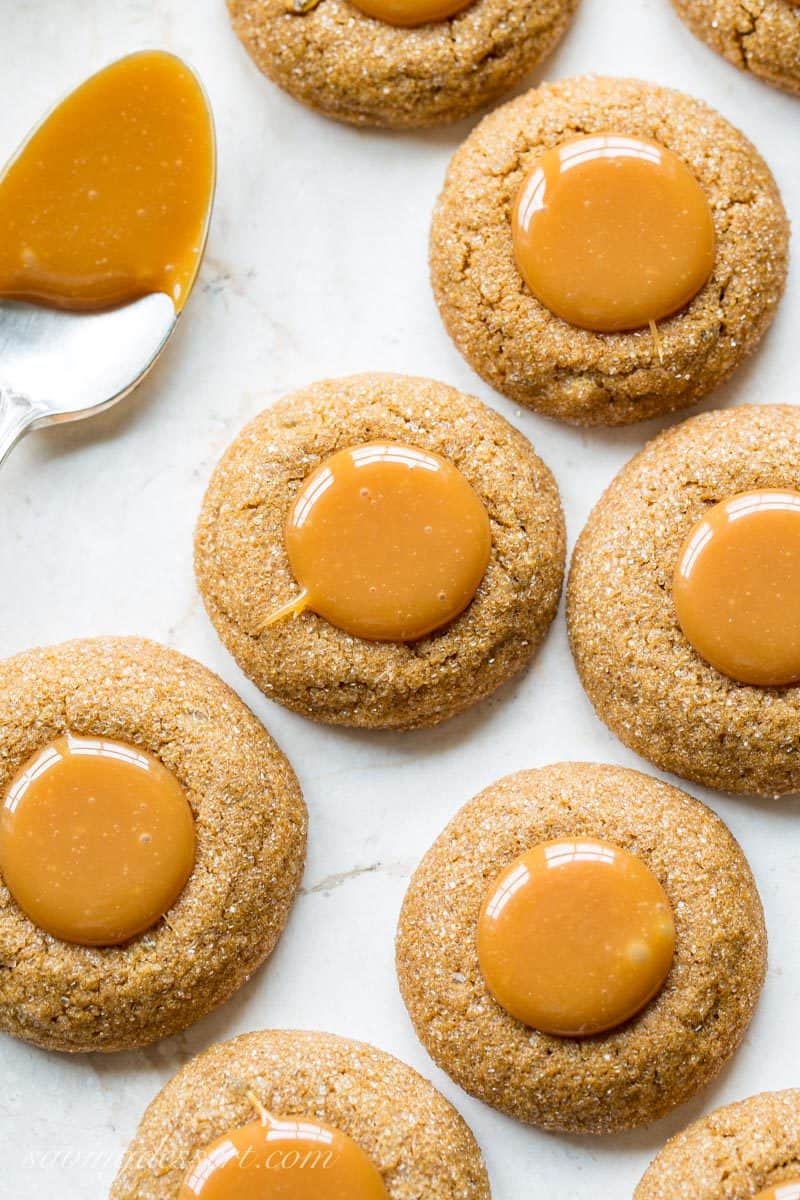 Ginger Molasses Thumbprint Cookies with Caramel ~ a terrific little molasses cookie with a crisp exterior, plenty of bite from the ginger, and a smooth, gooey milky caramel center.  www.savingdessert.com #savingroomfordessert #gingercookies #molassescookies #thumbprintcookies #thumbprint #christmascookies #cookies #caramelcookies