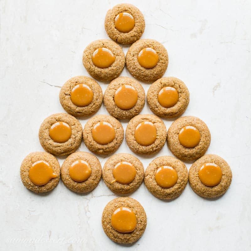 Ginger Molasses Thumbprint Cookies with Caramel ~ a terrific little molasses cookie with a crisp exterior, plenty of bite from the ginger, and a smooth, gooey milky caramel center.  www.savingdessert.com #savingroomfordessert #gingercookies #molassescookies #thumbprintcookies #thumbprint #christmascookies #cookies #caramelcookies