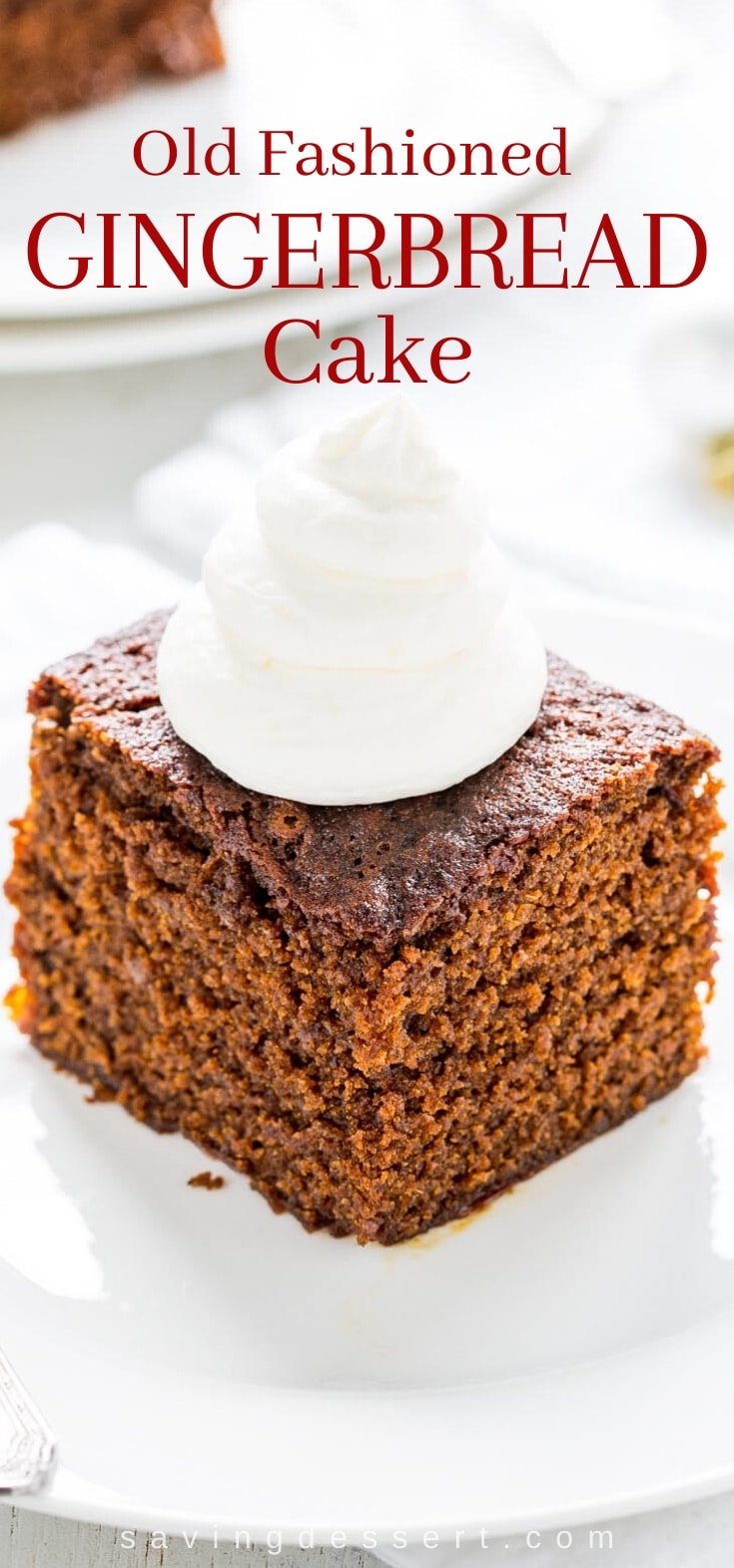 A slice of old fashioned gingerbread cake with lemon whipped cream on top