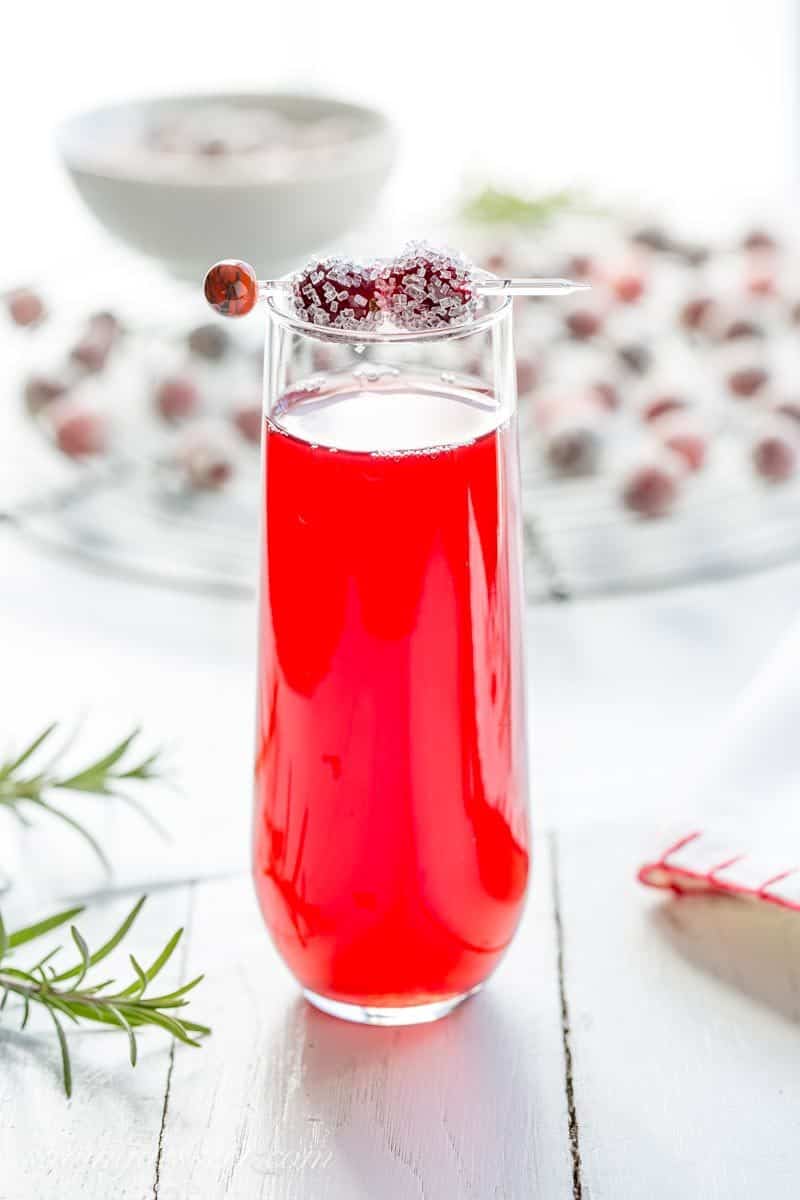 A holiday cocktail garnished with sugared cranberries