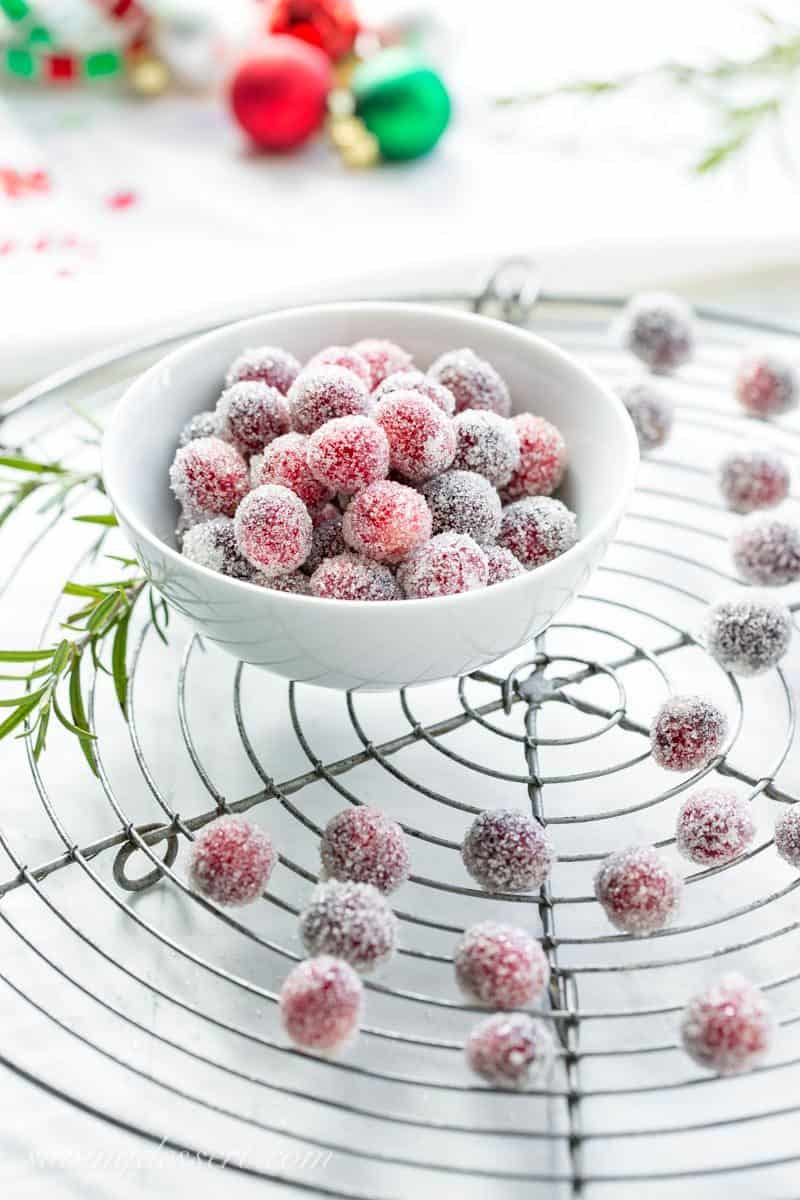 A bowl of sugar coated cranberries on a cooling rack