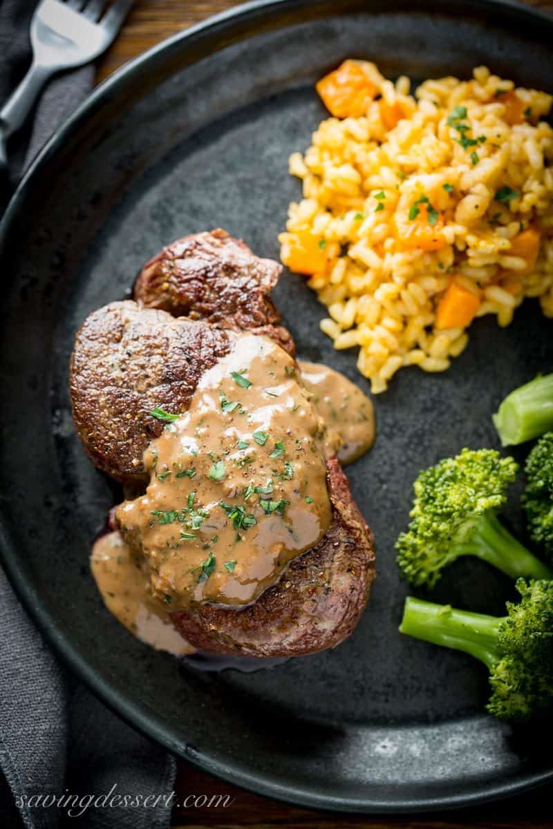 Thick and juicy Beef Tenderloin Steak with Herb Pan Sauce served with broccoli and rice