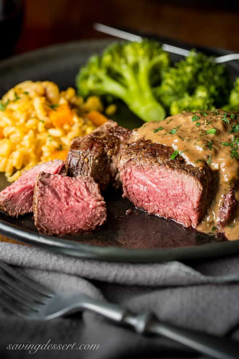 Medium rare Beef Tenderloin Steak with Herb Pan Sauce, rice and broccoli