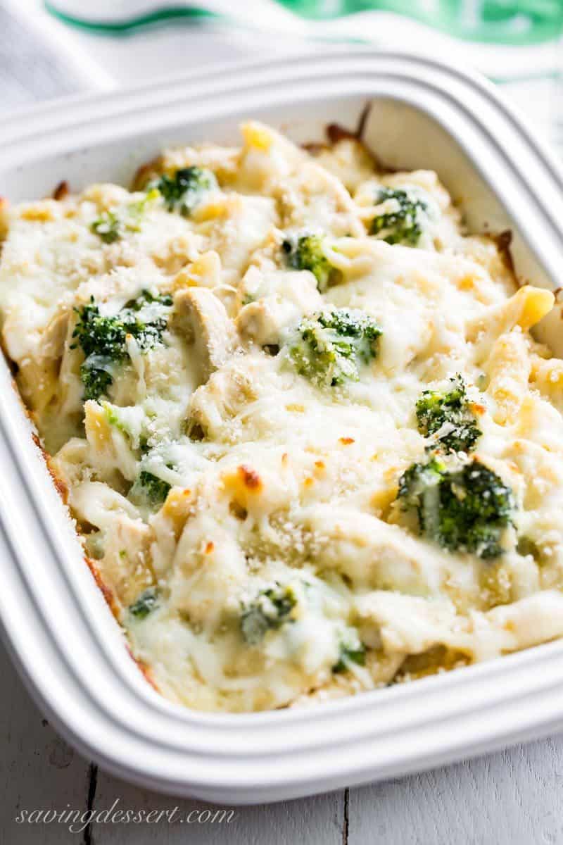 A small casserole dish with Penne pasta, broccoli and chicken with an Alfredo sauce