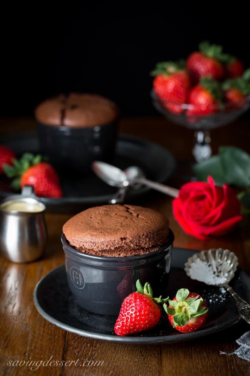 individual chocolate souffle with strawberries and a creme anglaise