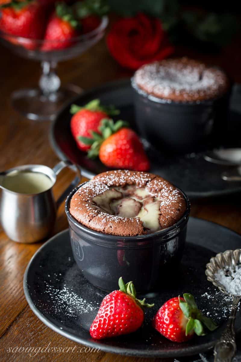 individual chocolate soufflés with a creme anglaise and strawberries