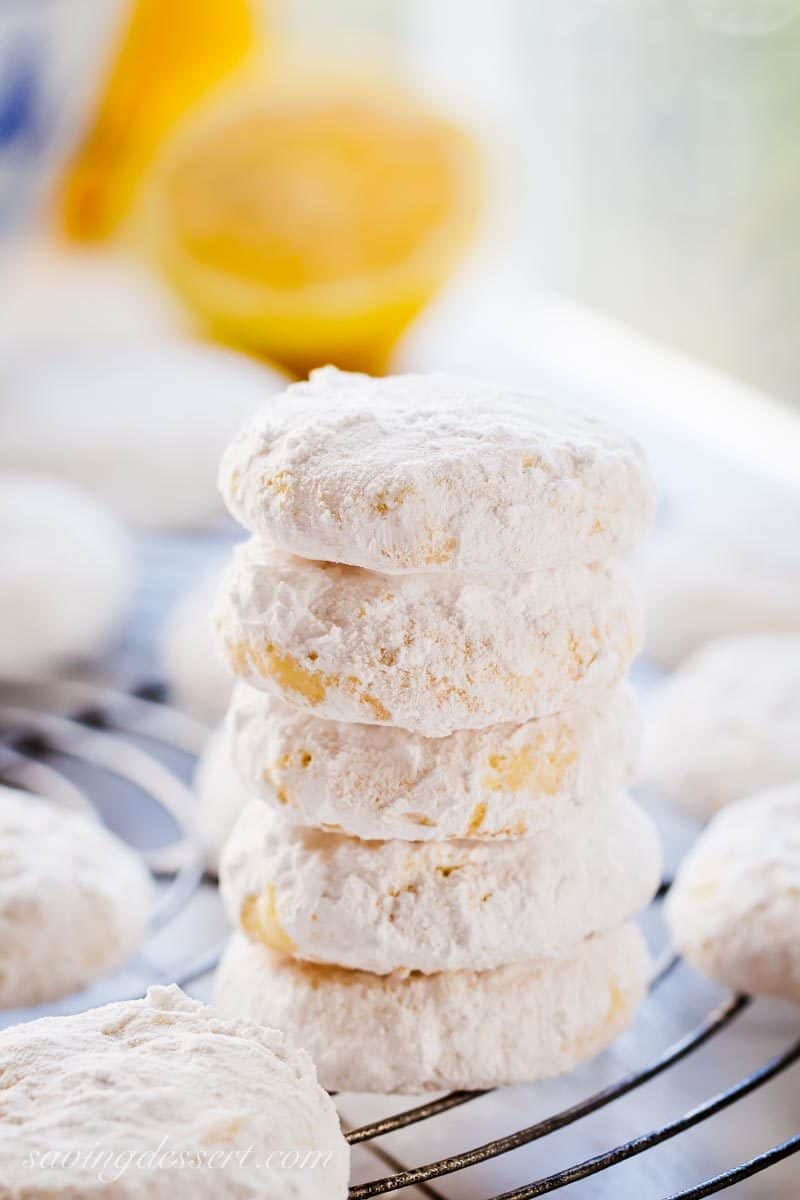 Powder sugar coated Lemon Cooler Cookies with lemons