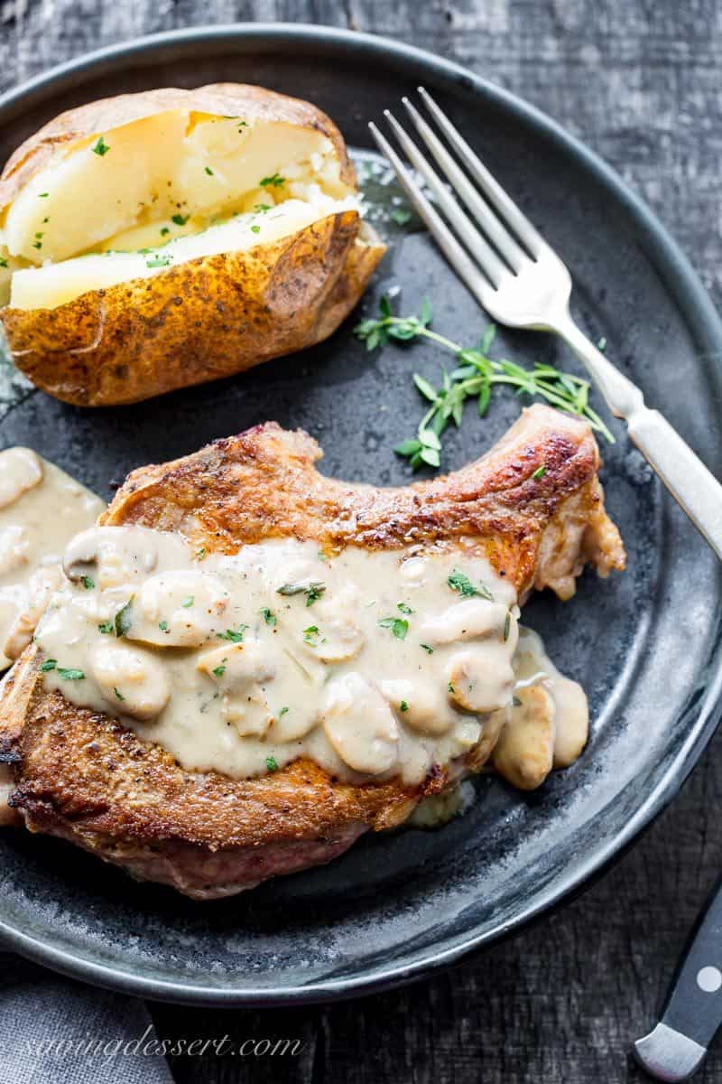 Pan seared, oven baked Pork Chops with Mushroom Wine Pan Sauce and a baked potato