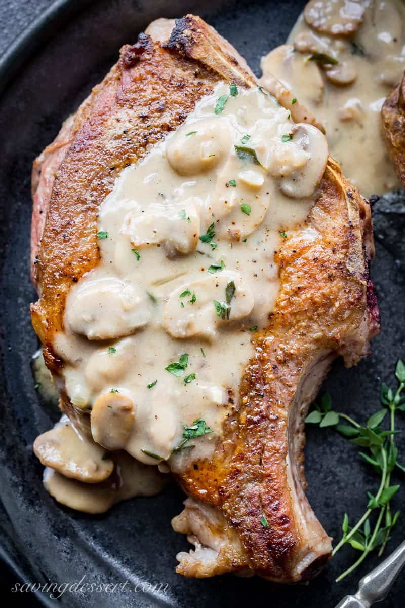 A large bone-in pork chop topped with mushroom gravy