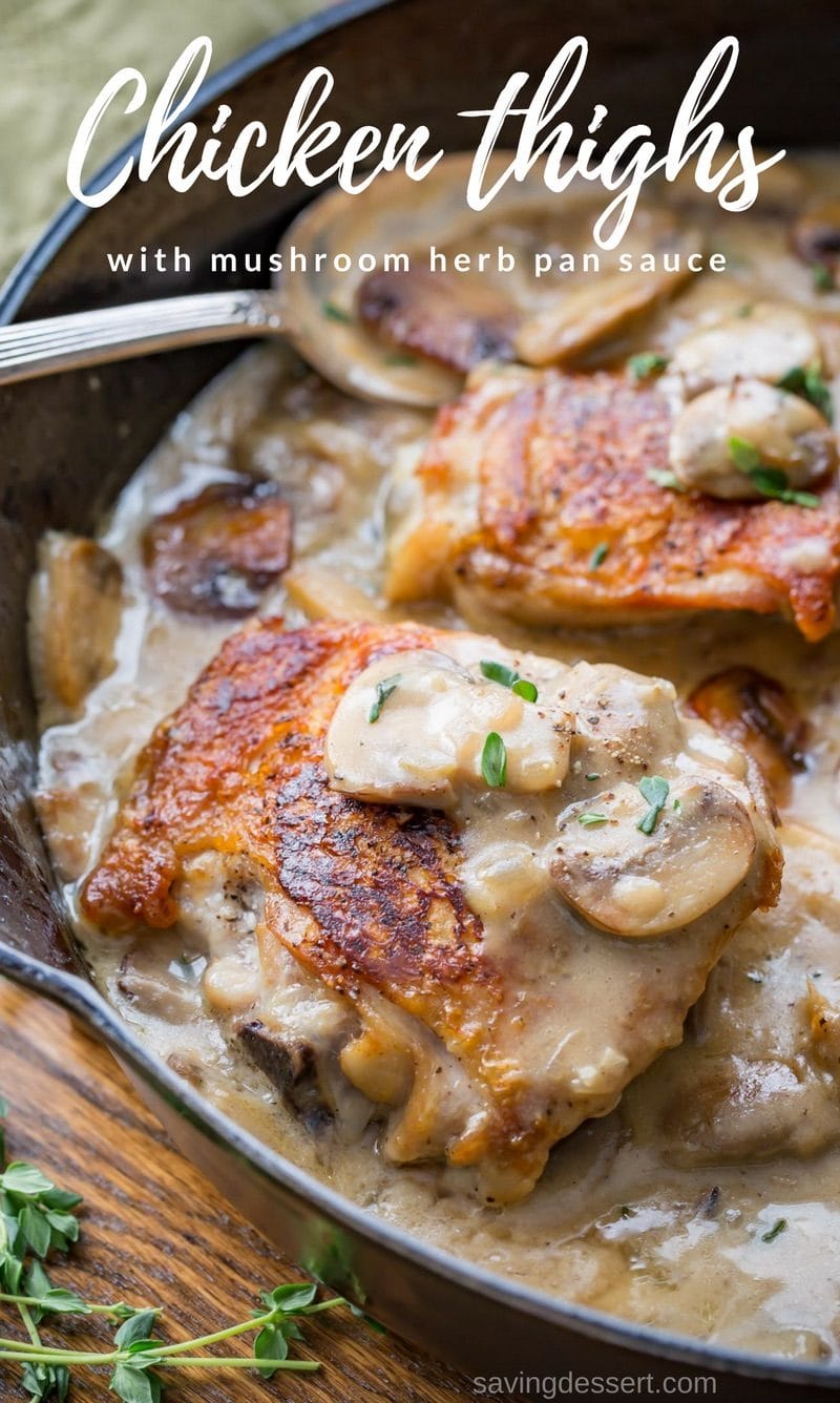 Cast iron skillet with crispy skin chicken thighs in a mushroom herb pan sauce