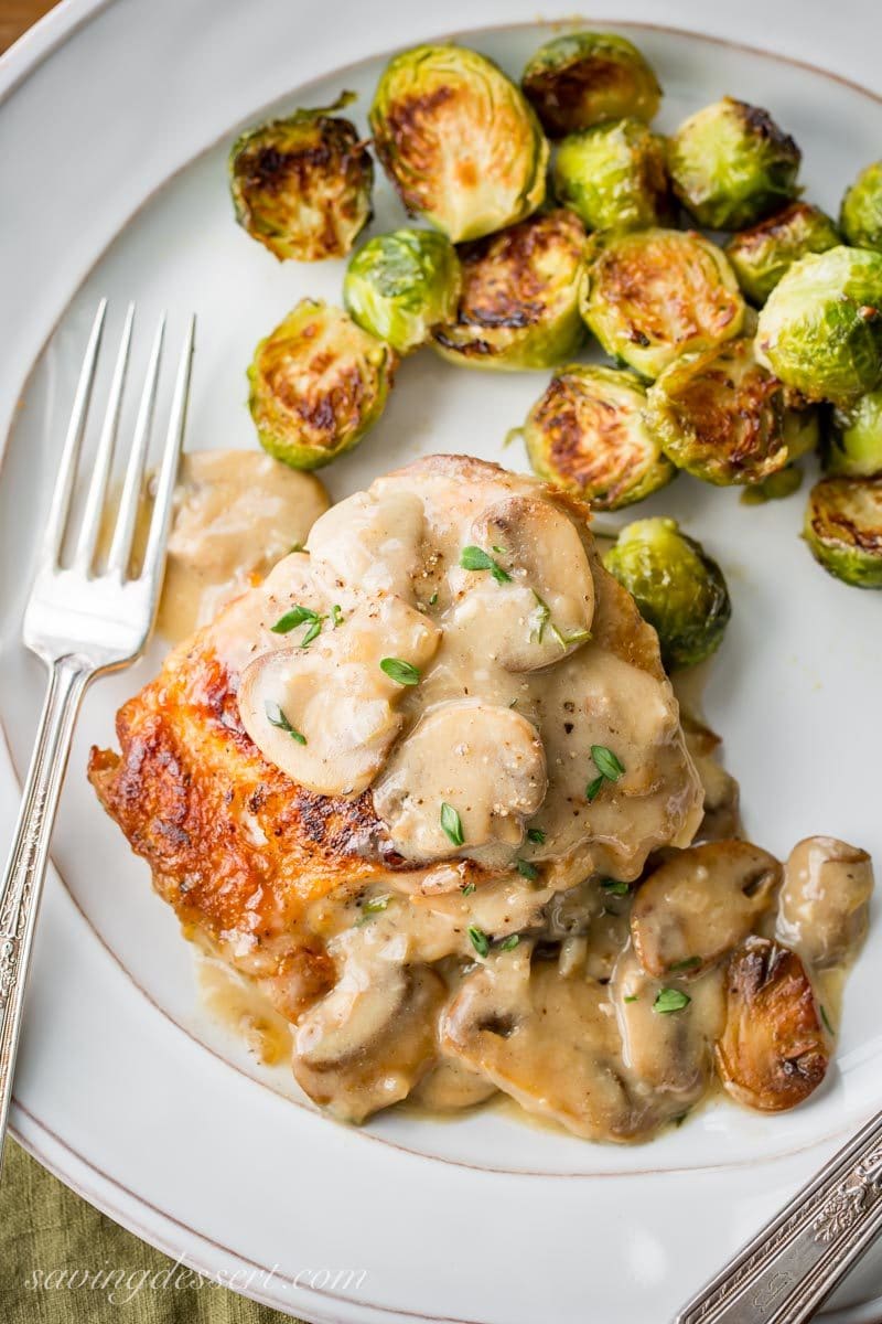 Crispy skin chicken thighs in a mushroom herb pan sauce served with Brussels Sprouts