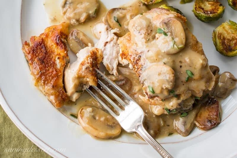 Crispy skin chicken thighs in a mushroom herb pan sauce served with Brussels Sprouts