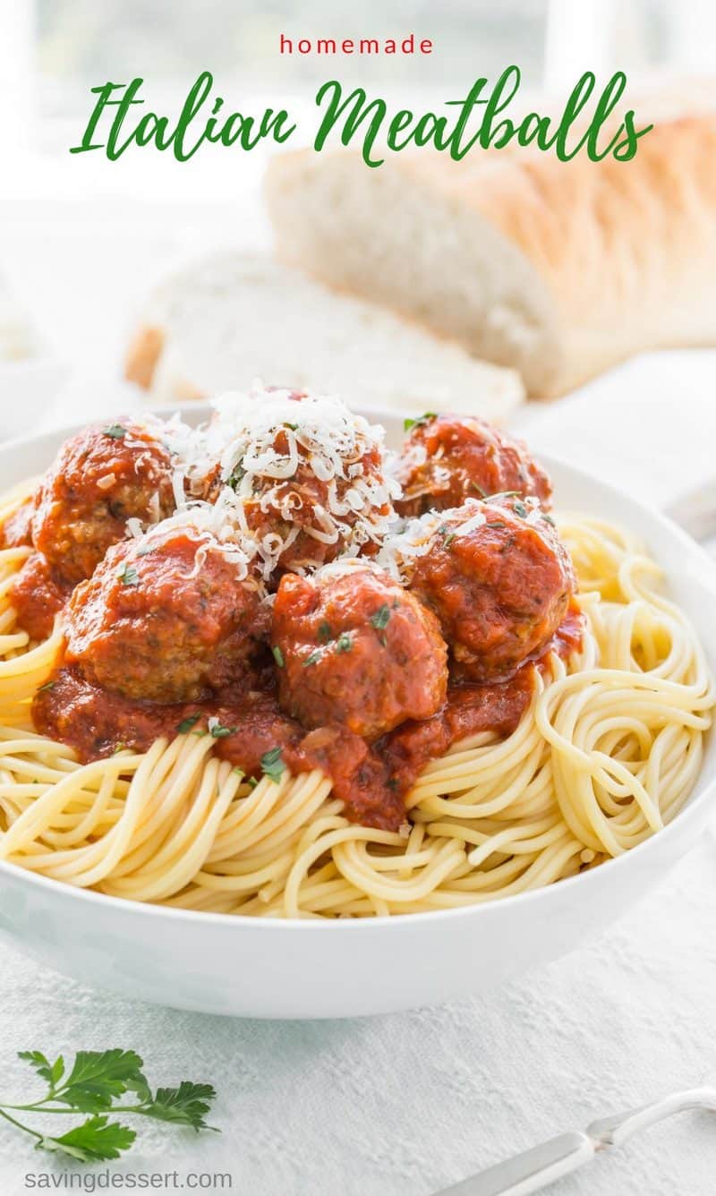 Bowl of spaghetti using a homemade Italian Meatball Recipe topped with fresh grated Parmesan Cheese