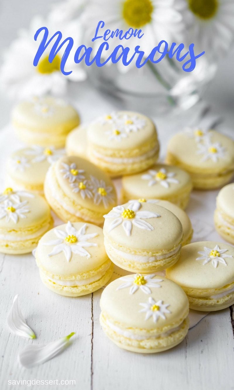 Brighten your day with these delicious Lemon Macarons decorated with a few brushstrokes of royal icing and sprinkles to help usher in the first warm days of spring. www.savingdessert.com #savingroomfordessert #macarons #lemon #cookies #meringuecookies #lemonmacarons #Italianmacarons