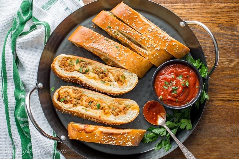 Sliced cheesy meatball stromboli with pizza sauce