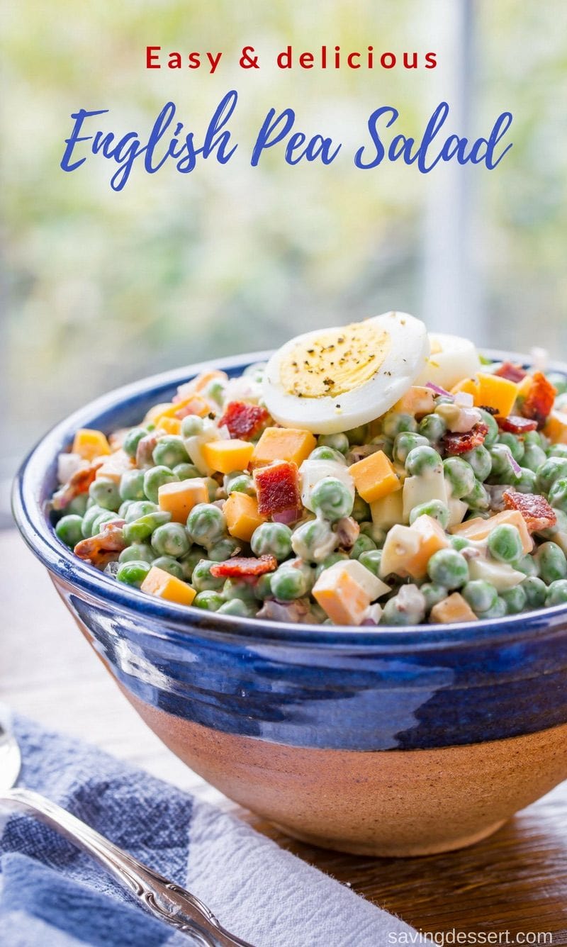 A bowl of pea salad topped with sliced hard cooked eggs