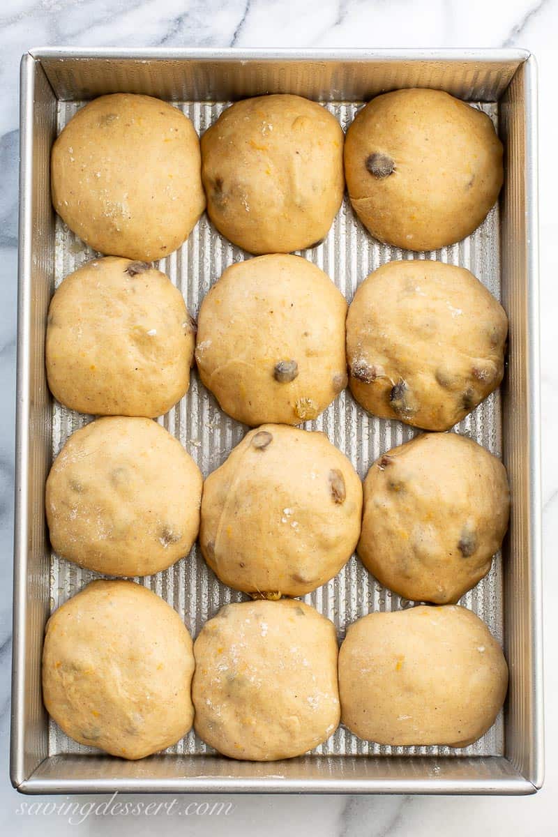 A pan of one dozen risen dough balls