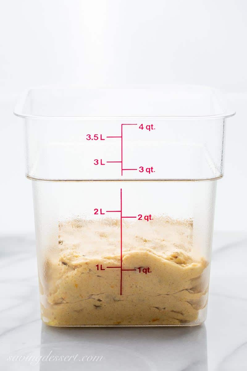 Dough in a clear container with measurements on the side