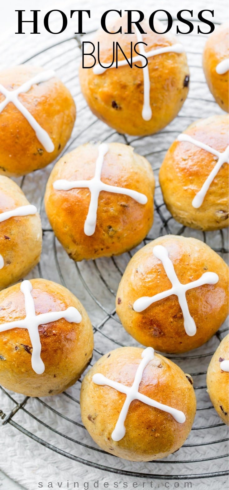  orangish scented yeast rolls alongside currants Hot Cross Buns
