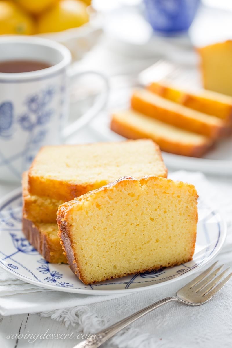 several slices of lemon ricotta pound cake with a cup of tea