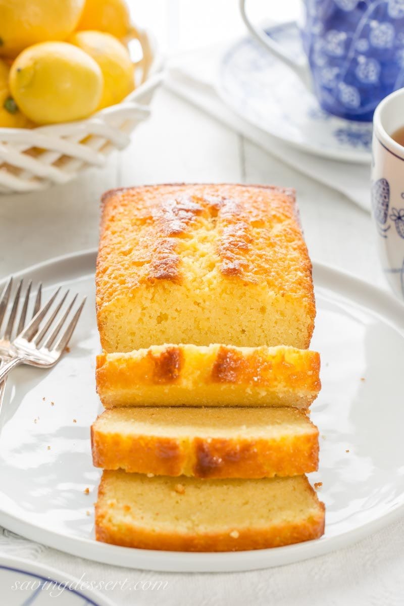 A sliced lemon ricotta pound cake with a cup of tea