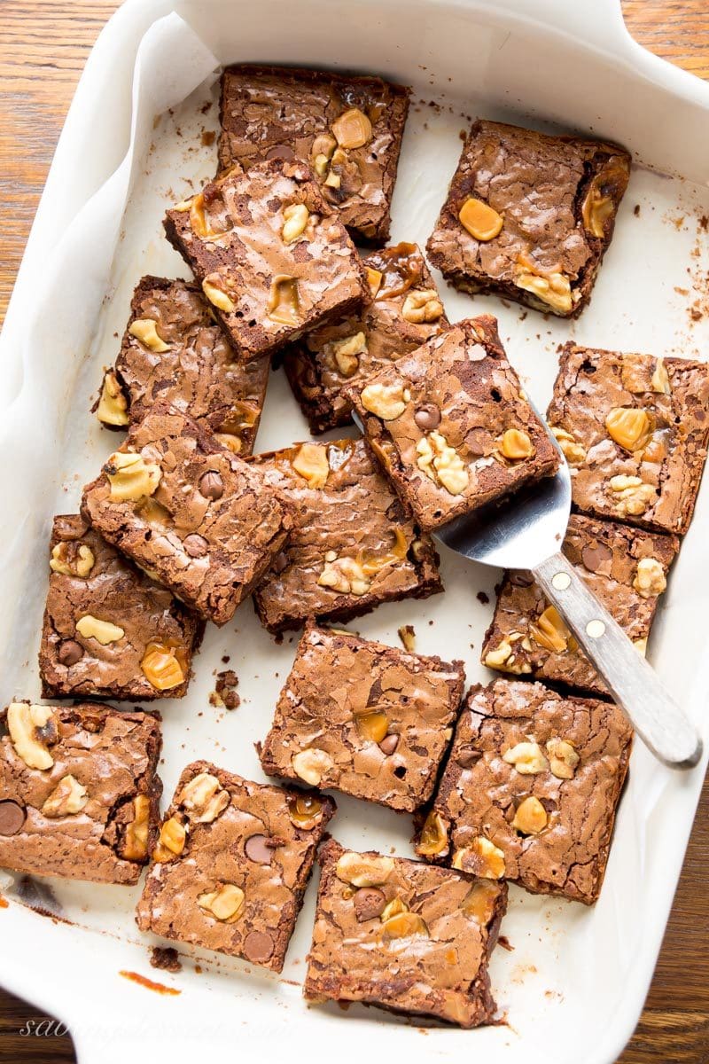 A pan of chocolate brownies with walnuts, chocolate chips and caramel