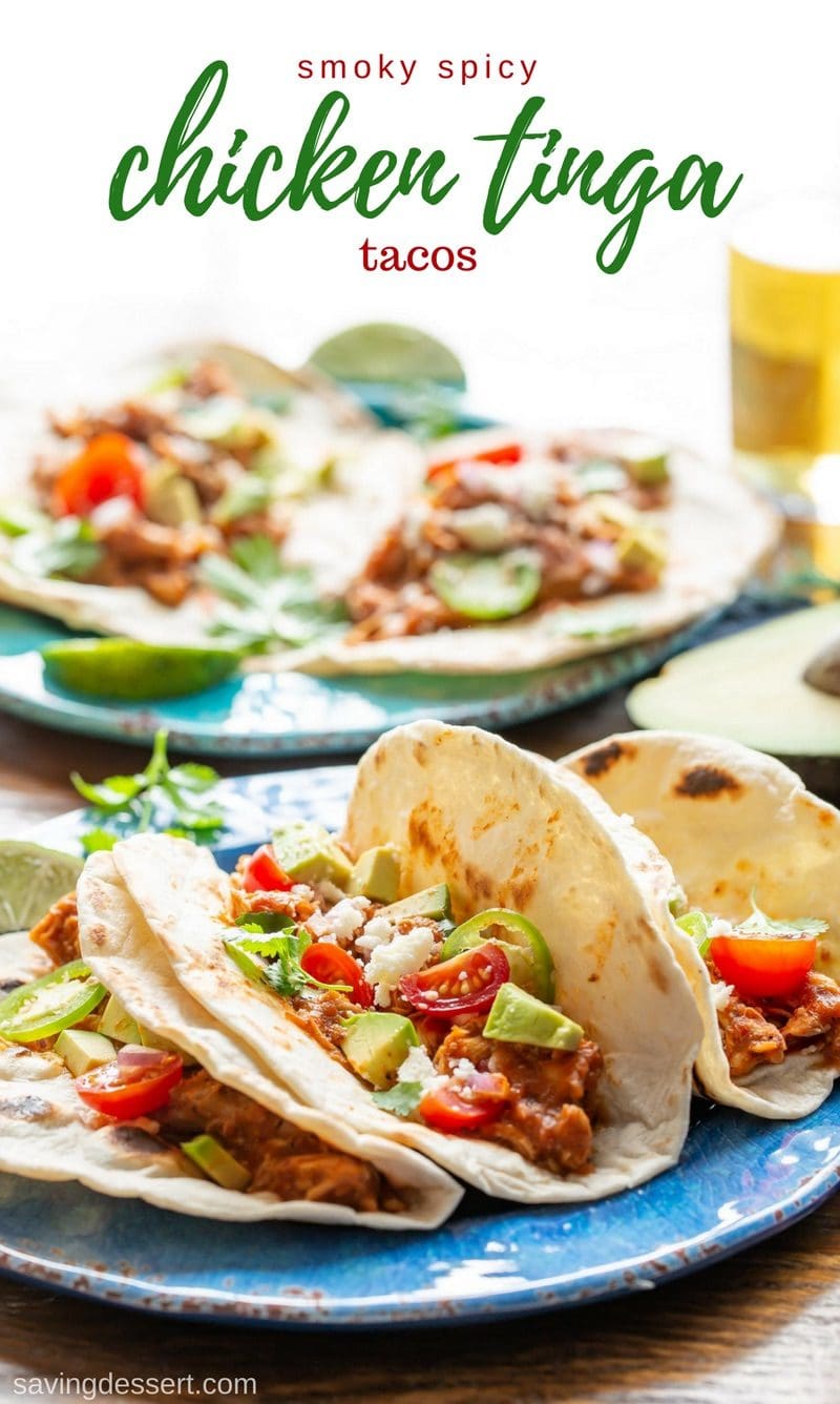 Smoky Chicken Tinga Tacos (tinga de pollo) - a flavorful Mexican dish made with fire roasted tomatoes, chipotle chilis in adobo sauce, and tender, shredded chicken. Serve as a topping for tostadas with a layer of refried beans, or as a filling for tacos, this delicious smoky chicken won't get lost under layers and layers of toppings! #savingroomfordessert #chickentacos #tacotuesday #tinga #chickentinga #cincodemayo #mexican #adobosauce #chipotle