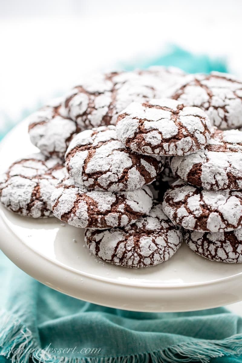 A stack of chocolate crinkle cookies on a platter
