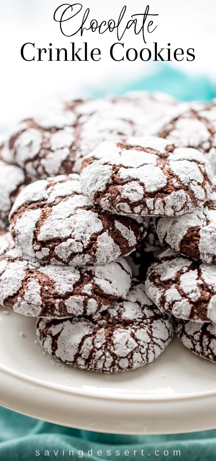 Chocolate Crinkle Cookies stacked on a cake platter