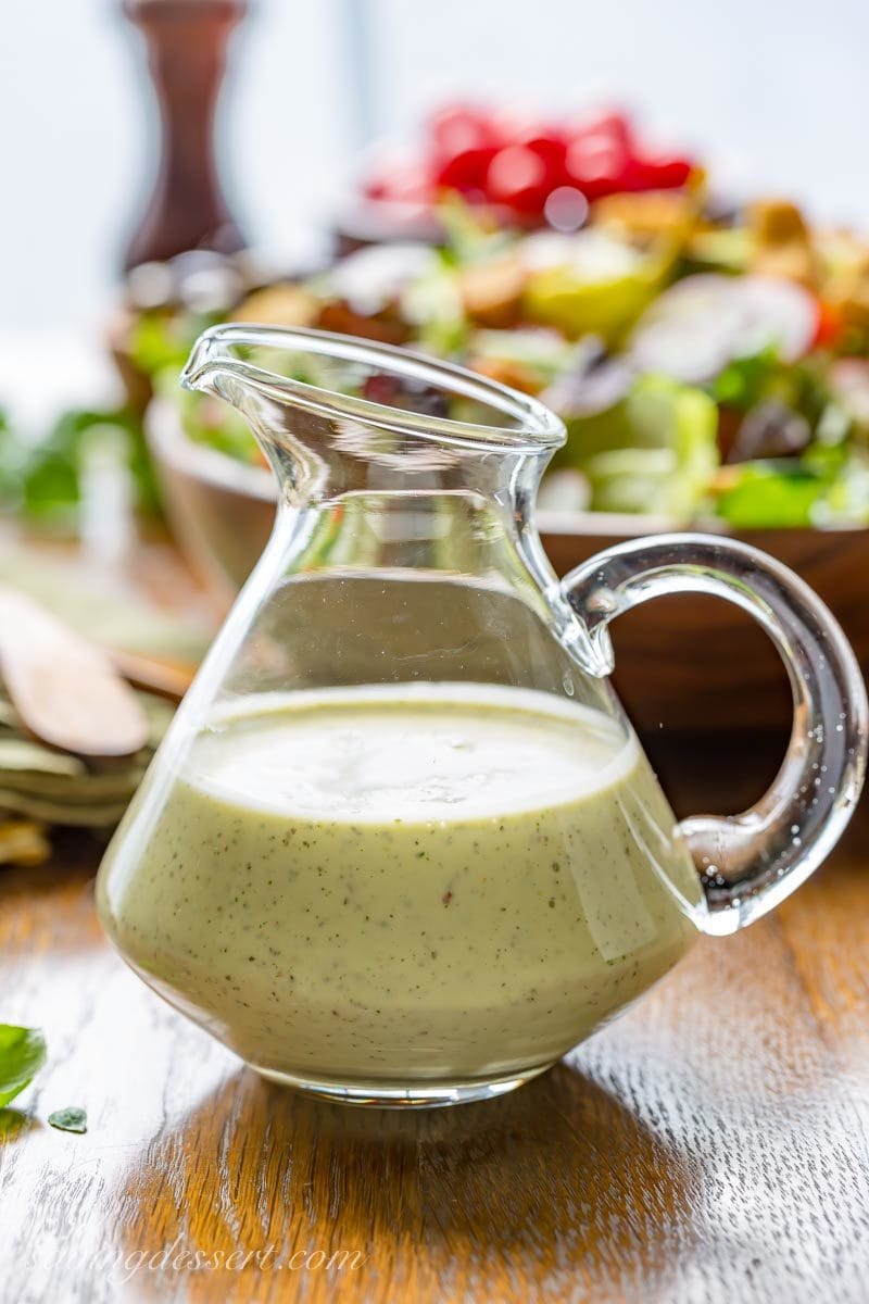 a cruet with homemade Creamy Italian Dressing and a fresh tossed salad