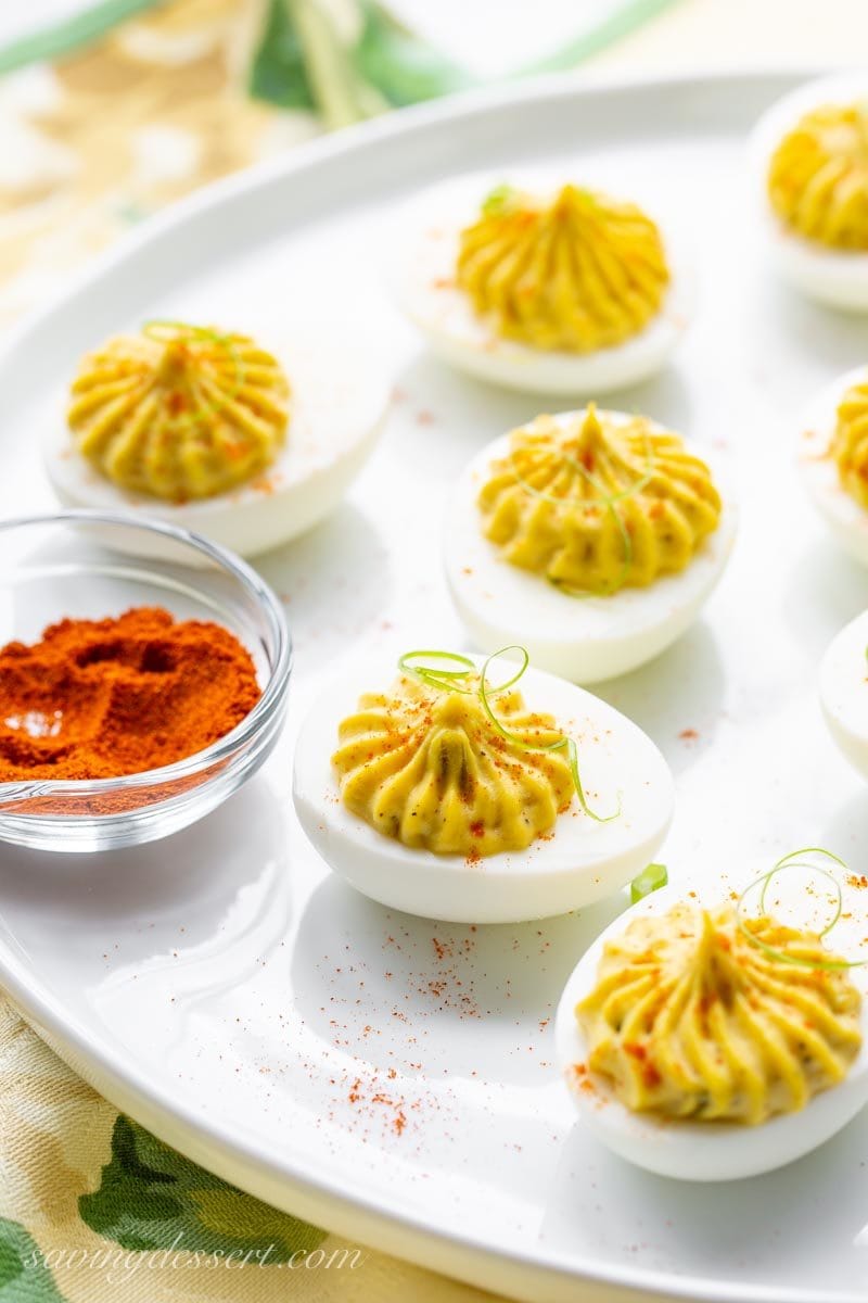 a plate of deviled eggs  garnished with spices