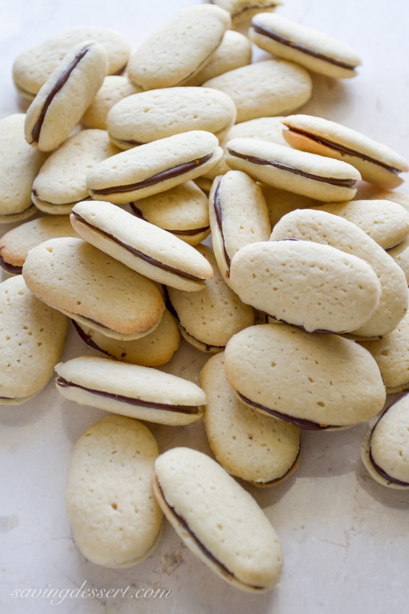 copycat Orange Milano Cookies with a chocolate filling in a pile