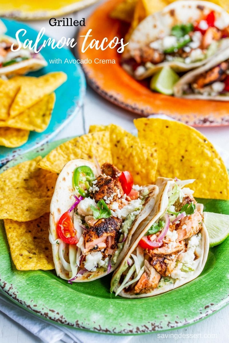 Colorful plates with chips and Grilled Salmon Tacos with avocado crema and limes