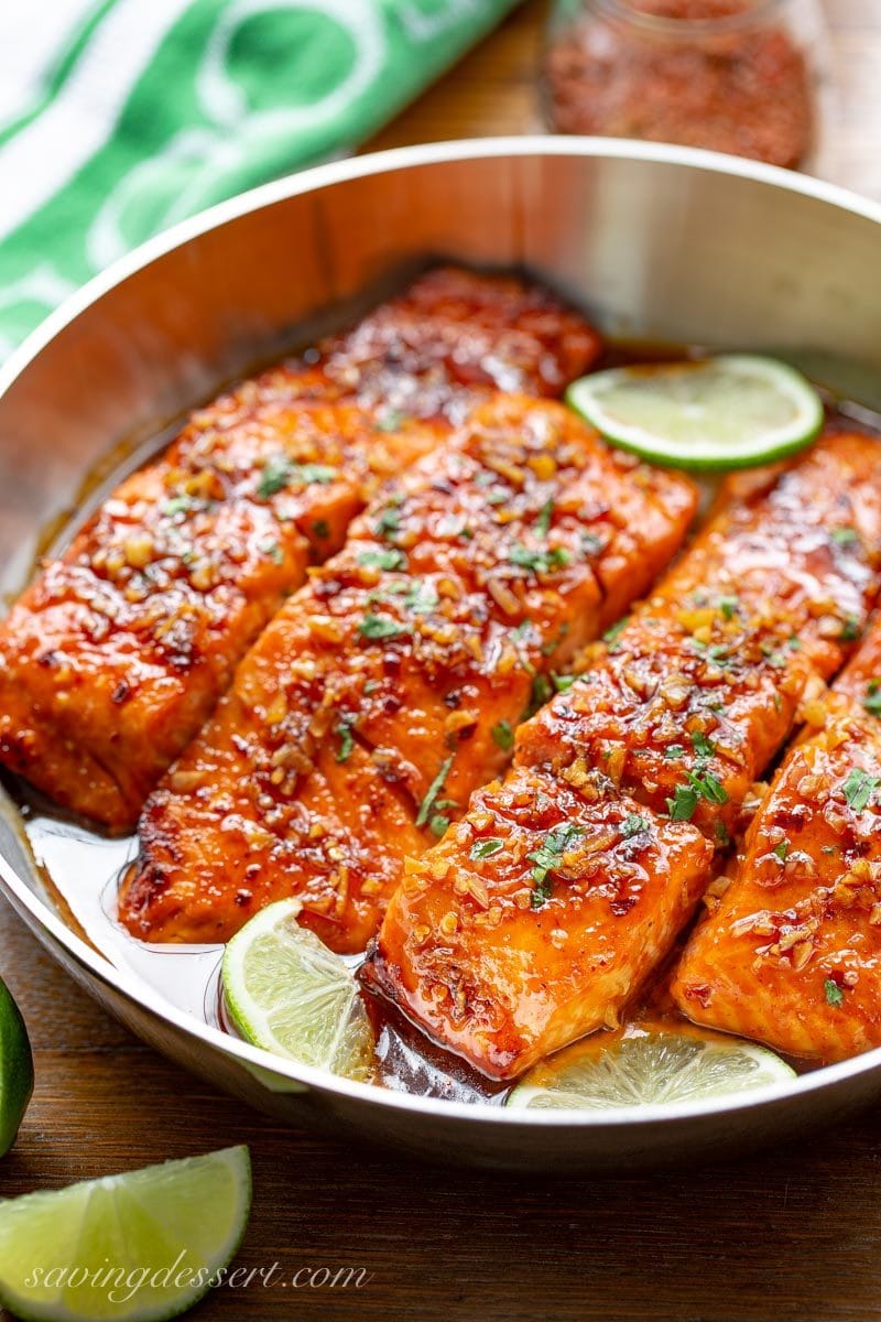 Spicy Honey Glazed Salmon in a skillet with a honey-lime garlic sauce.