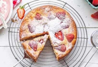 Sliced strawberry breakfast cake dusted with powdered sugar