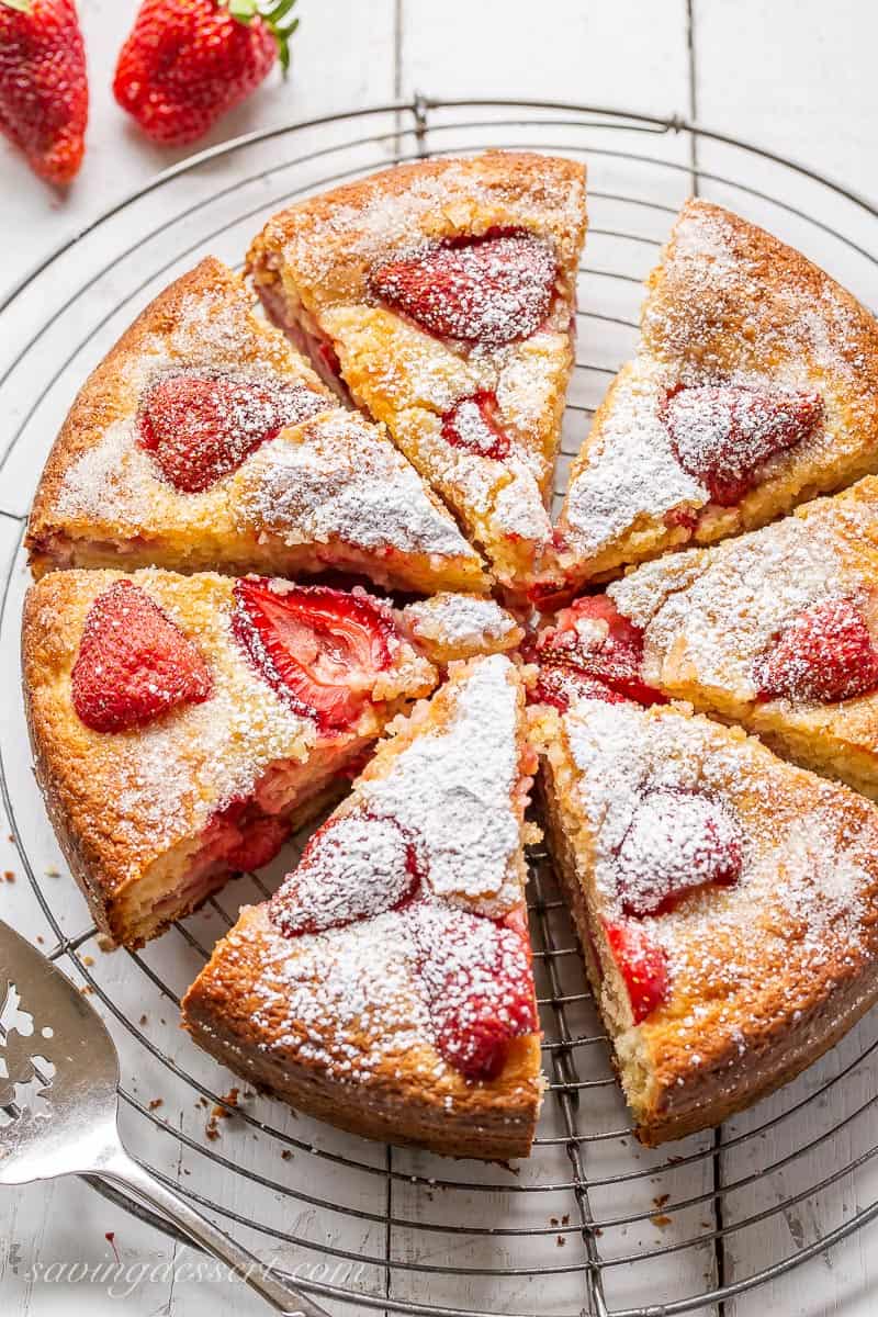 Sliced strawberry cake on a wire cooling rack