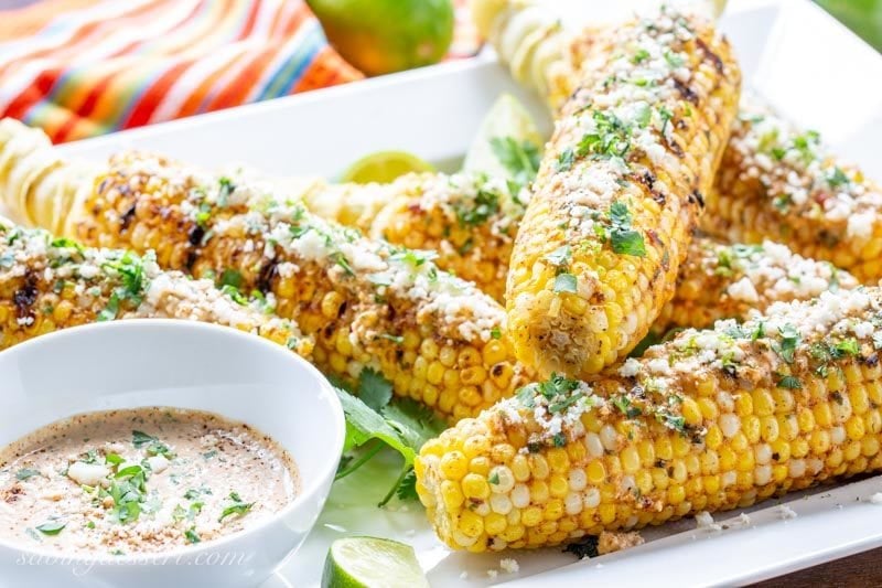 Grilled ears of corn with cheese and lime