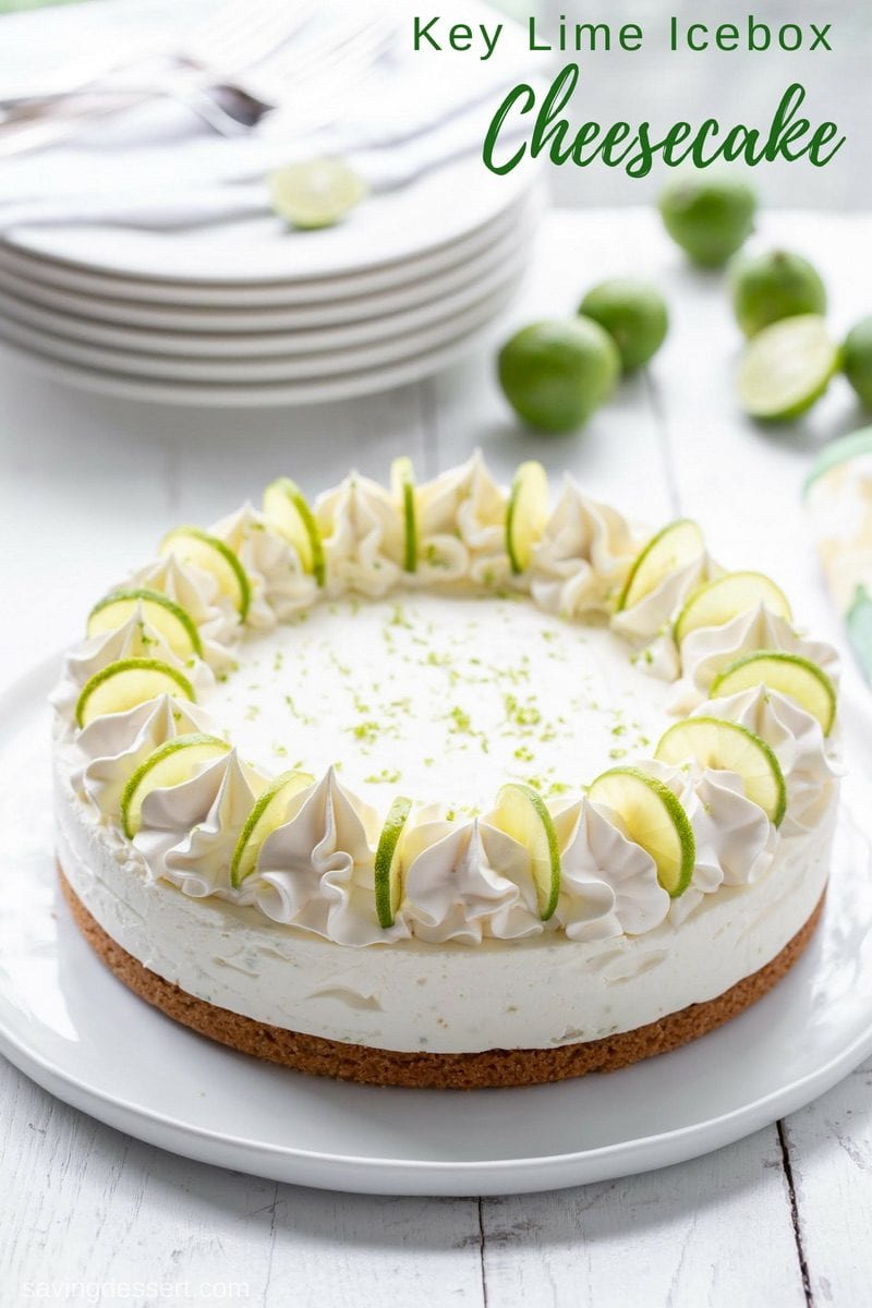 A whole icebox cheesecake on a platter. Garnished with key lime slices and whipped cream