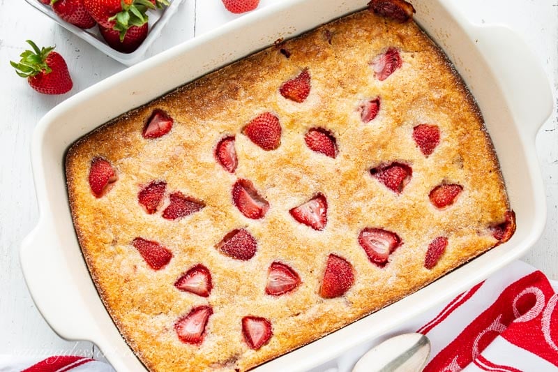 An overhead view of a baking pan filled with strawberry buckle dessert.