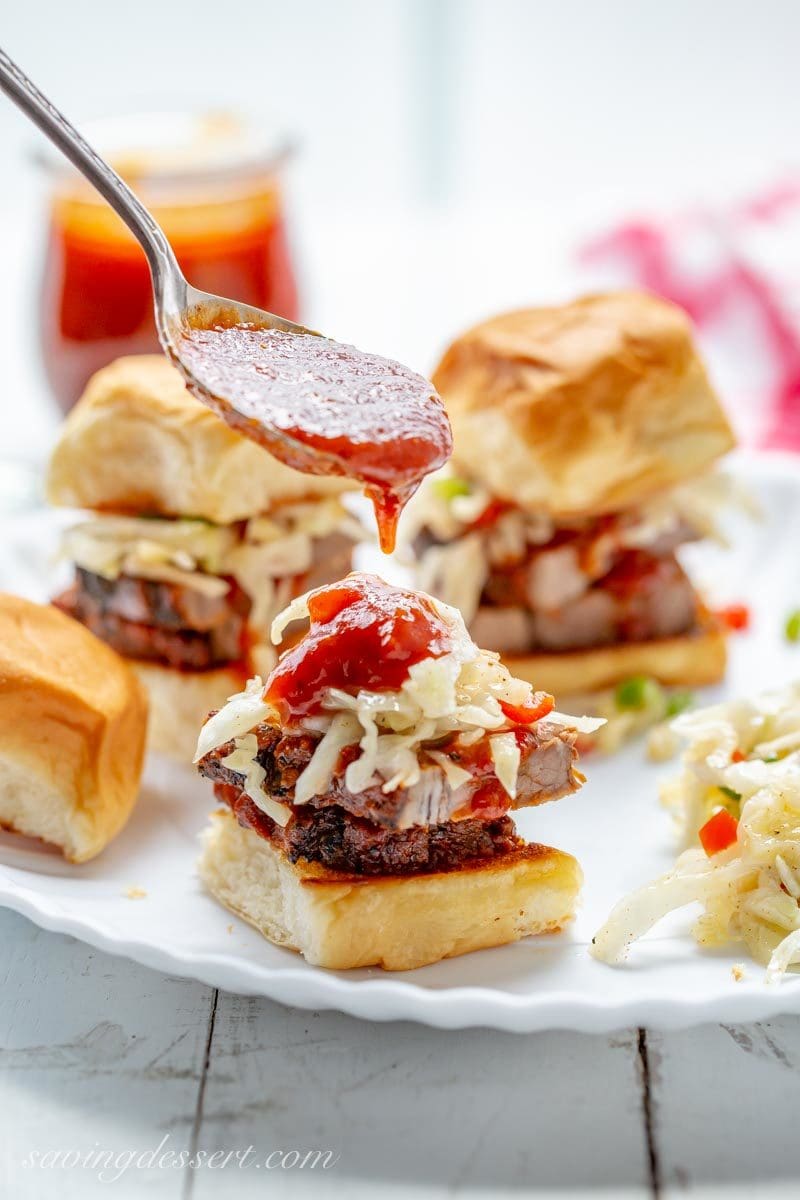 Toasted rolls with sliced beef brisket, Cole slaw and BBQ sauce - sliders!