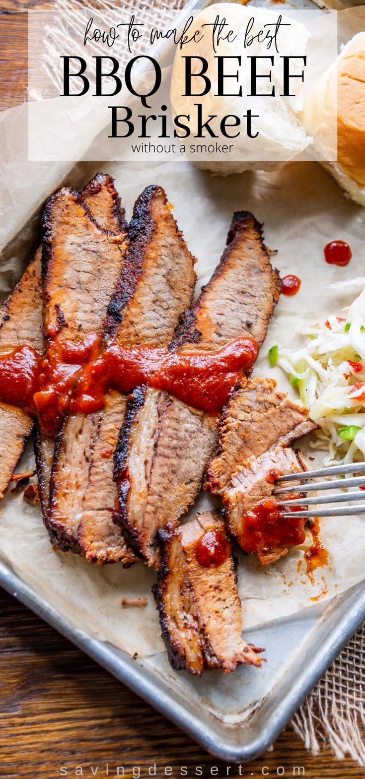 Sliced BBQ Beef brisket on a try served with rolls and cole slaw