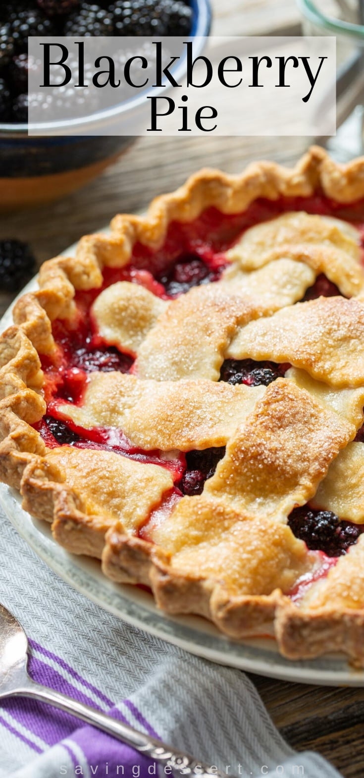 A homemade blackberry pie with purple juices poking through the lattice crust