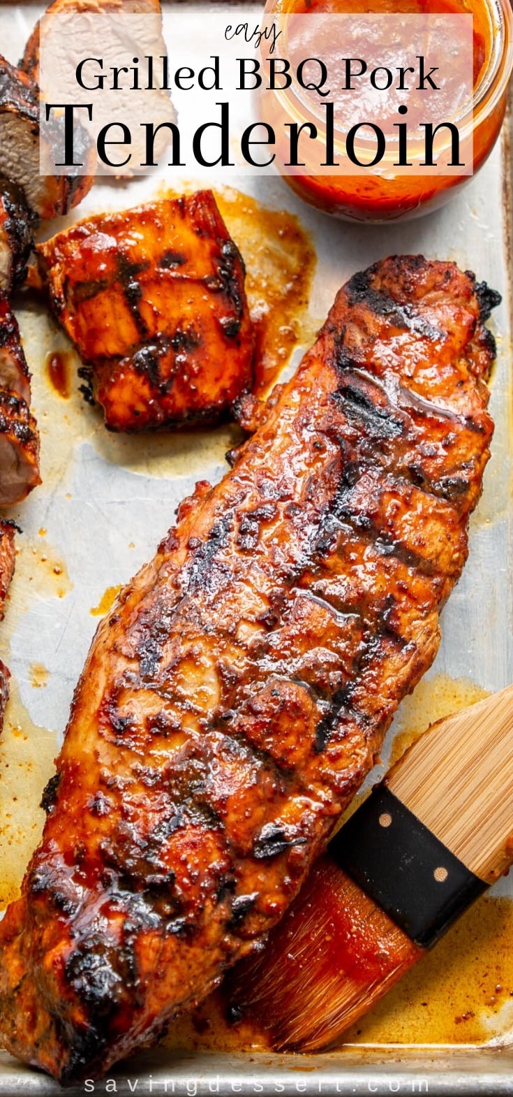 A baking tray with grilled and BBQ'd pork tenderloins with sauce on the side