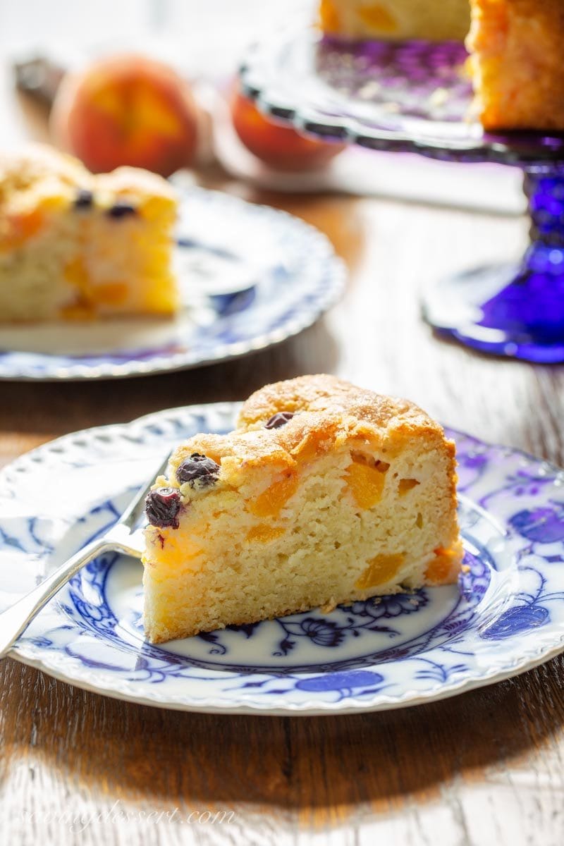 Sliced fresh Peach Breakfast Cake with blueberries