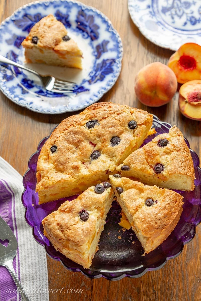 Sliced fresh peach breakfast cake with blueberries