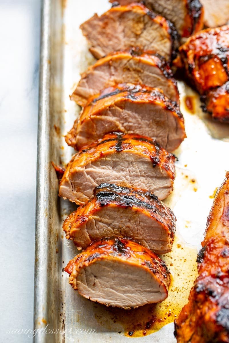 Sliced Grilled BBQ Pork Tenderloin on a baking pan