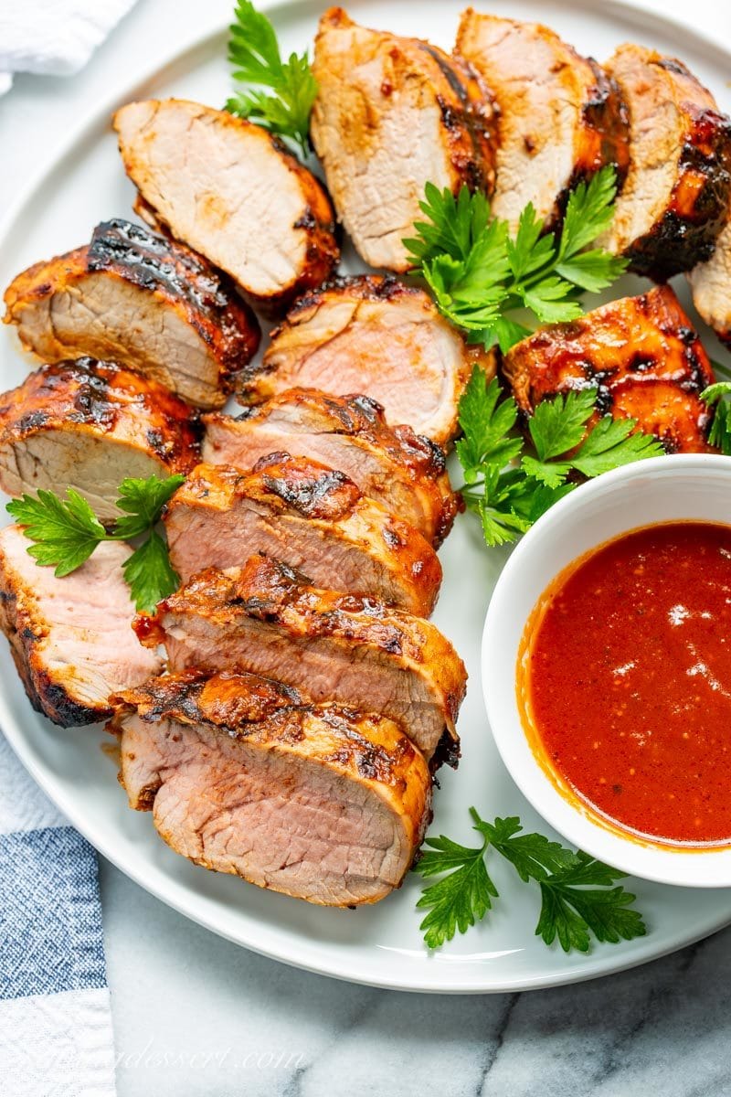 sliced, grilled BBQ pork tenderloin with extra Honey BBQ Sauce on the side